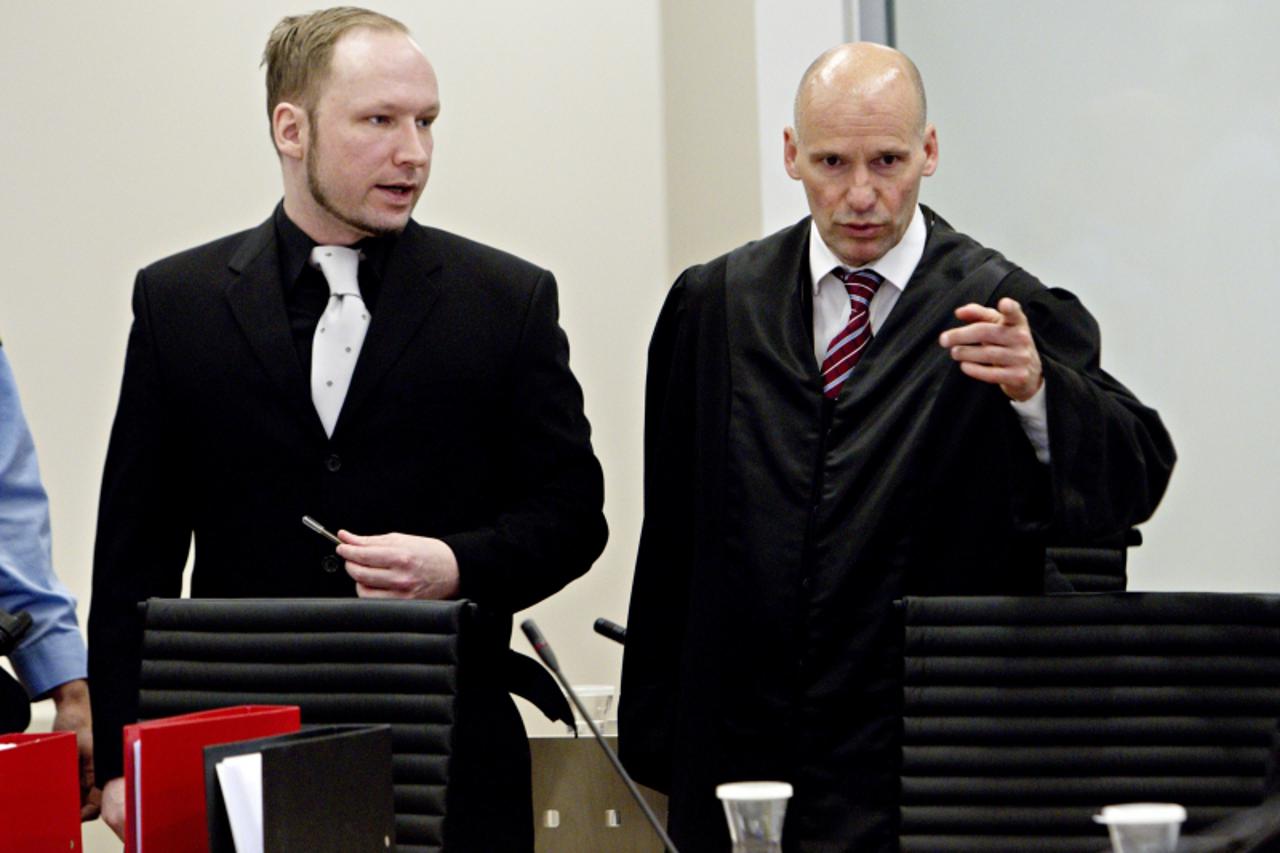 'self-confessed mass murderer and right-wing extremist Anders Behring Breivik talks with his defence lawyer Geir Lippestad in the courtroom on the fifth-day of his murder trial in Oslo on April 20, 20
