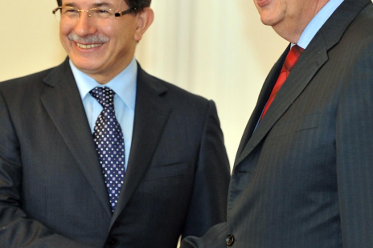 'Foreign Minister of Turkey, Ahmet Davutoglu (L) is greeted by member of Bosnian tripartite Presidency, Nebojsa Radmanovic (R) upon arrival for talks in Sarajevo, on October 20, 2010. Davutoglu arrive