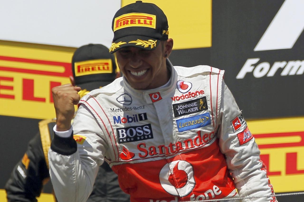 'McLaren Formula One driver Lewis Hamilton of Britain celebrates his victory during the podium ceremony following the Canadian F1 Grand Prix at the Circuit Gilles Villeneuve in Montreal June 10, 2012.