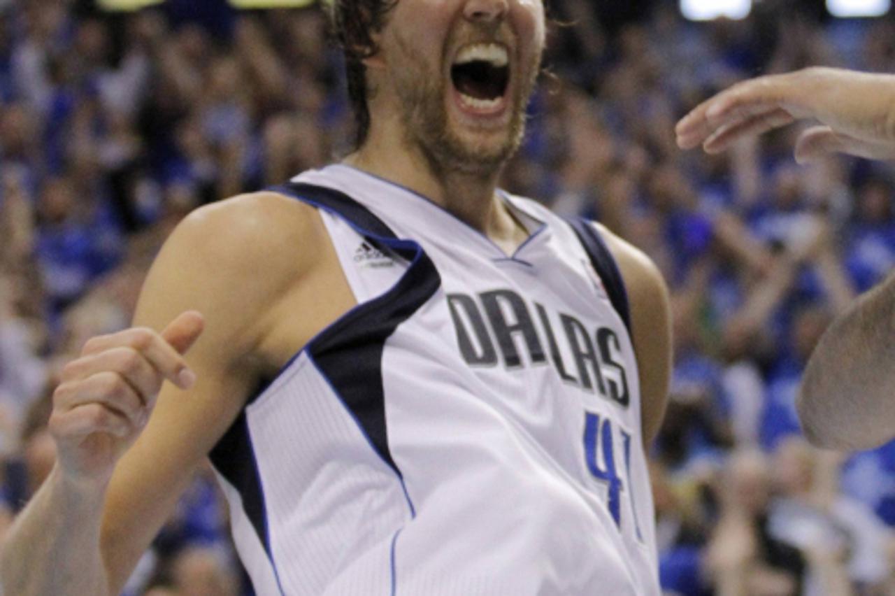 'Dallas Mavericks\' Dirk Nowitzki of Germany celebrates during Game 5 of the NBA Western Conference Final basketball playoff against the Oklahoma City Thunder in Dallas, Texas May 25, 2011. REUTERS/Ti