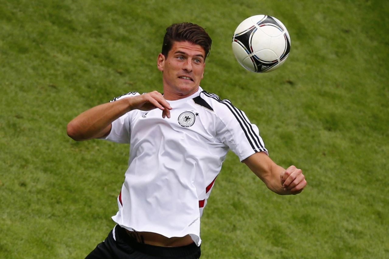 'File picture shows Mario Gomez of Germany's national soccer jumping for a header during a practice session of the team at the stadium in Warsaw, June 27, 2012. Gomez will leave Bayern Munich and joi