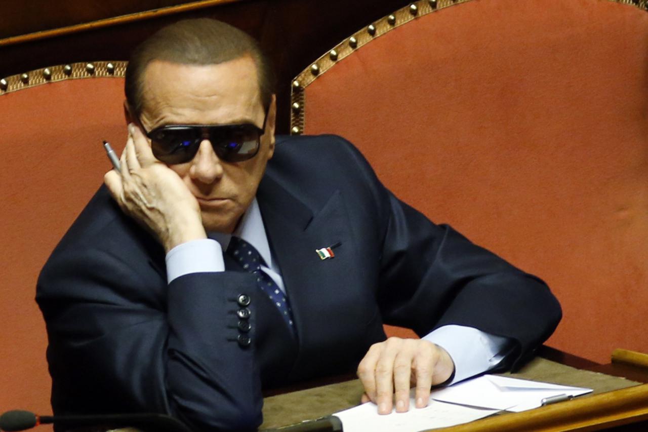 'Italy's former prime minister Silvio Berlusconi attends a session at the Senate in Rome March 16, 2013. Italy's divided parties failed to overcome their differences in a vote for parliamentary spea