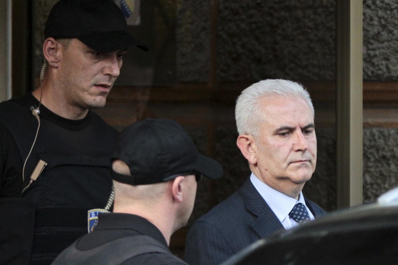 'Members of the special police arrest President of Bosnia\'s autonomous Muslim-Croat federation Zivko Budimir (R) in Sarajevo April 26, 2013.  The president of Bosnia\'s autonomous Muslim-Croat federa