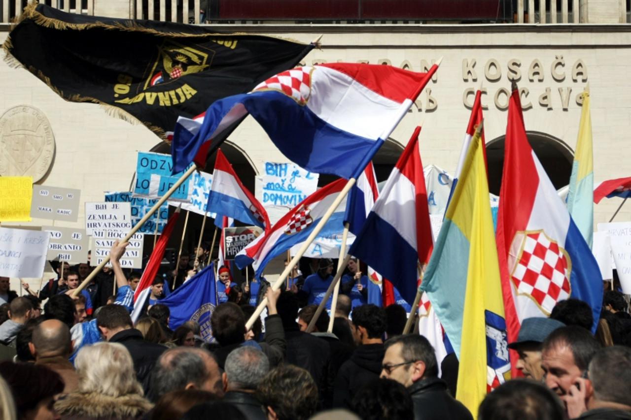 \'Bosnian Croat youth wave flags in Mostar on March 17, 2011, during protest against systematic breaking of their constitutional rights through outvoting by Bosnian Muslim majority in Muslim-Croat Fed