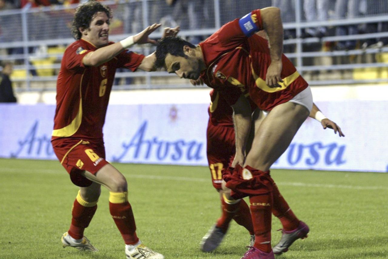 \'Montenegro\'s Mirko Vucinic (R) celebrates his goal against Switzerland with team mates during their Euro 2012 qualifying soccer match in Podgorica, October 8, 2010.  REUTERS/Stevo Vasiljevic (MONTE