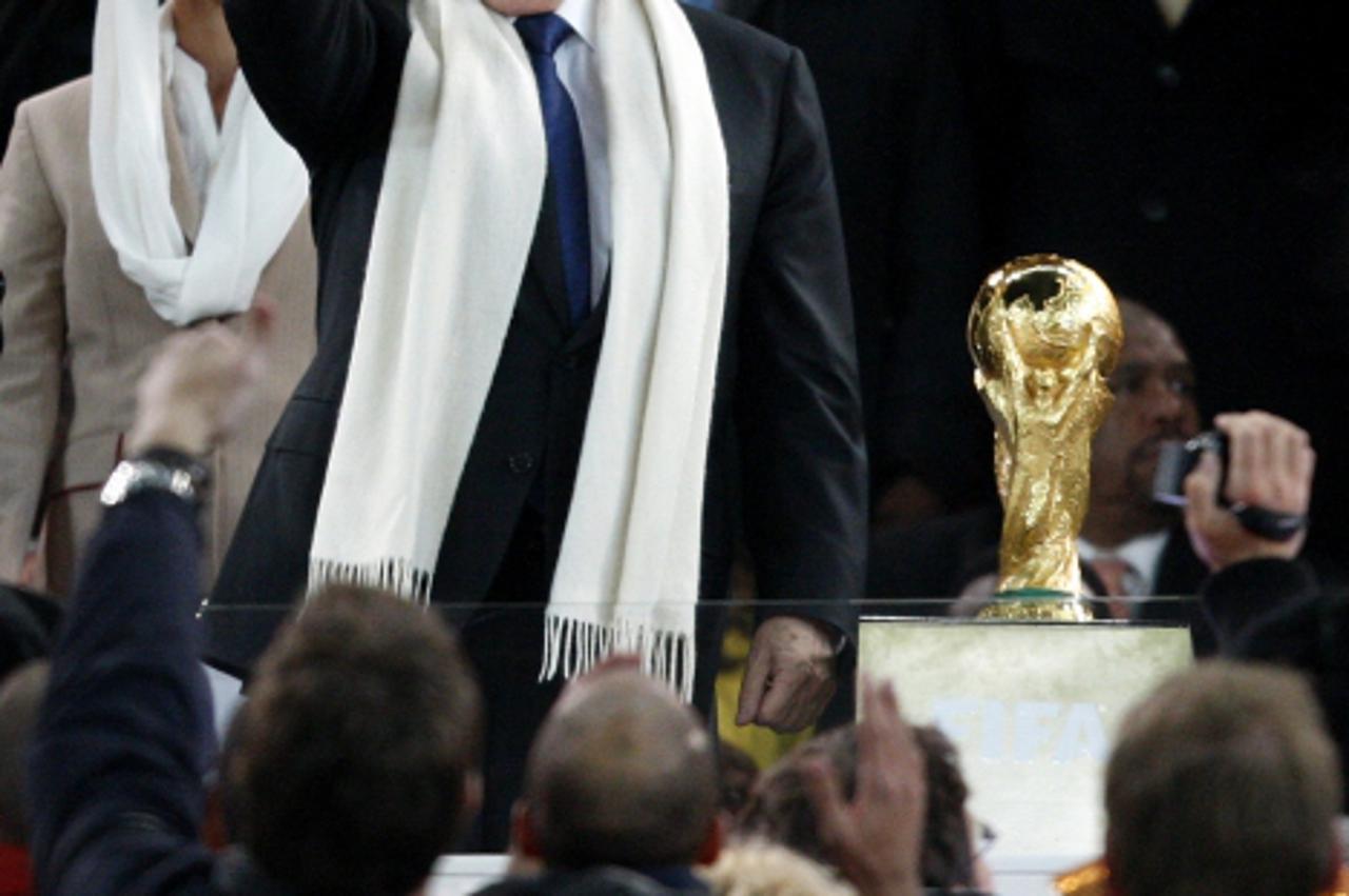 \'FIFA president Sepp Blatter (left) gives the fans the thumbs up as he prepares to hand over the World Cup trophy to Spain  Photo: Press Association/Pixsell\'