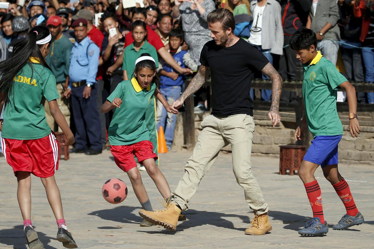 David Beckham kicks a ball during the charity match to collect funds for the United Nations Children's Fund (UNICEF) at the ancient city of Bhaktapur, Nepal November 6, 2015. REUTERS/Navesh Chitrakar      TPX IMAGES OF THE DAY