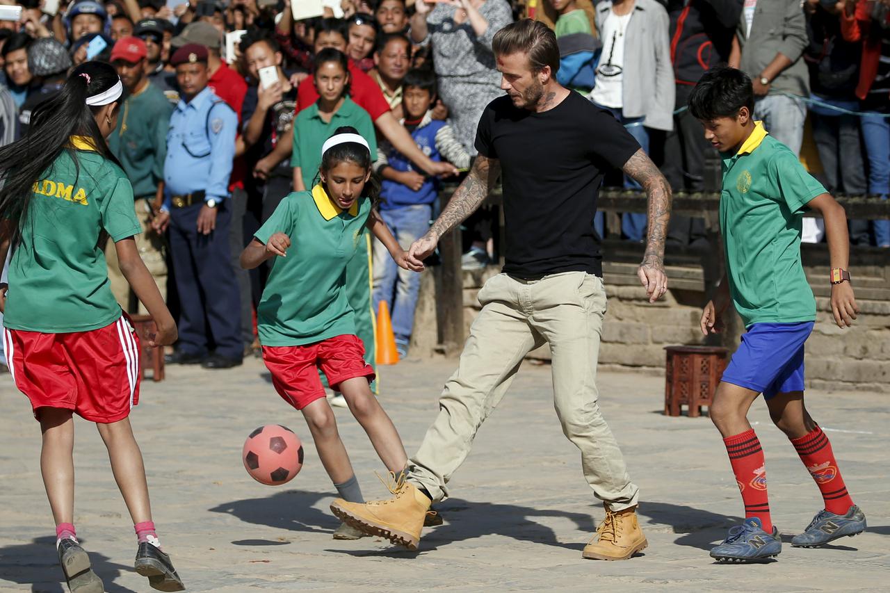 David Beckham kicks a ball during the charity match to collect funds for the United Nations Children's Fund (UNICEF) at the ancient city of Bhaktapur, Nepal November 6, 2015. REUTERS/Navesh Chitrakar TPX IMAGES OF THE DAY