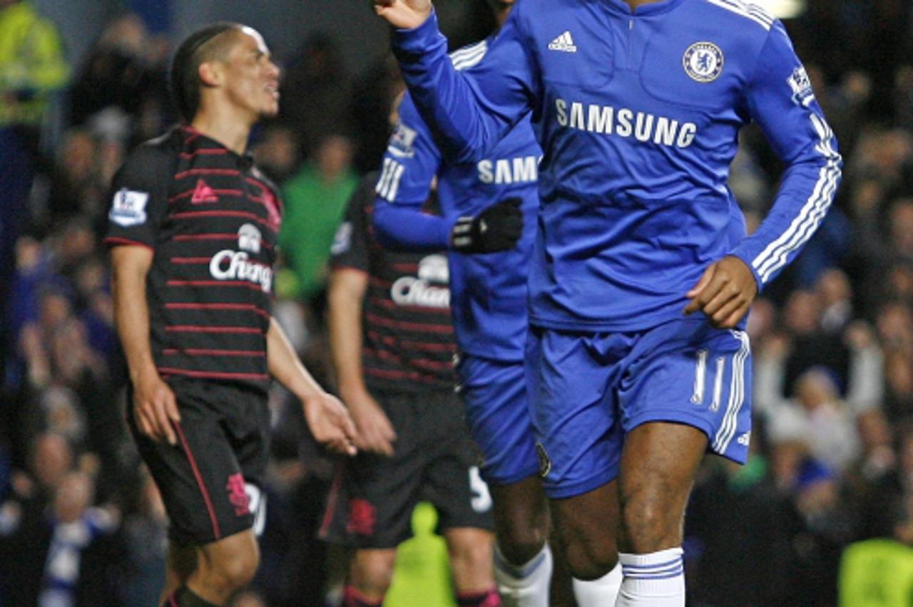 'Chelsea\'s Ivorian striker Didier Drogba (R) celebrates scoring his second goal during the English Premier League football match between Chelsea and Everton at Stamford Bridge, London on December 12,
