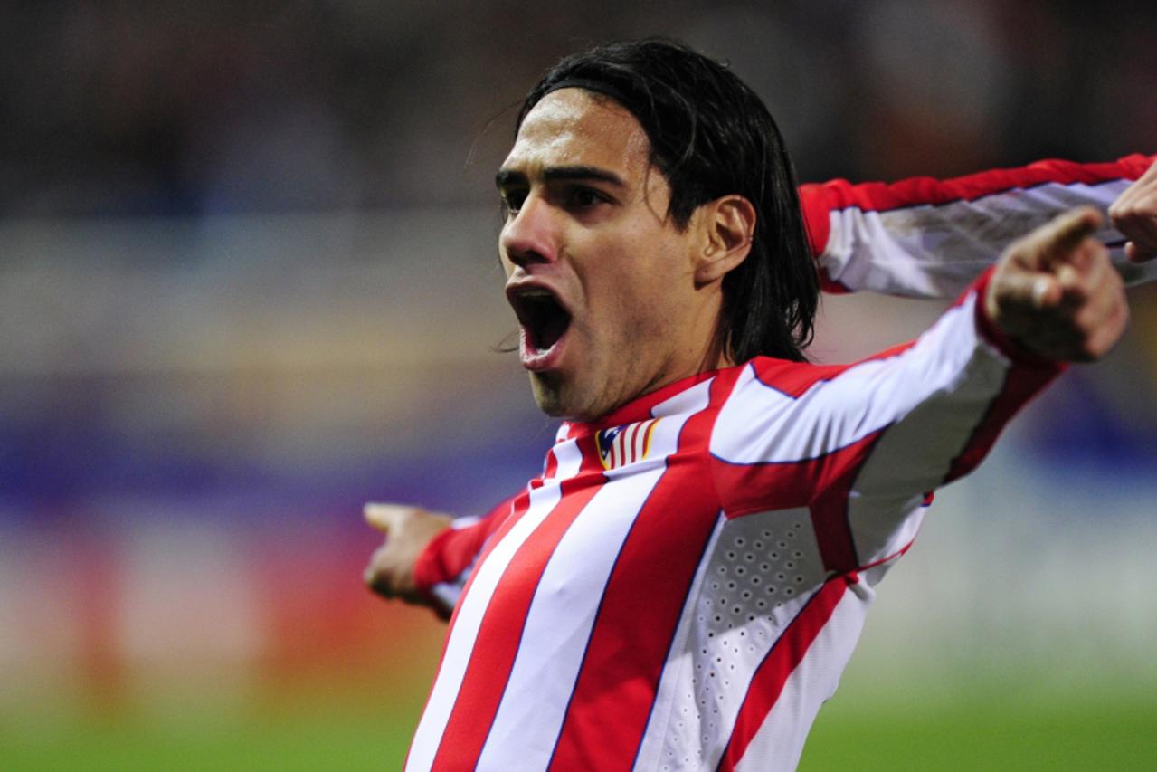 'Atletico Madrid's Colombian midfielder Radamel Falcao celebrates  after scoring his team's fourth goal during the UEFA Europa League first leg semi-final football match Atletico Madrid vs Valencia