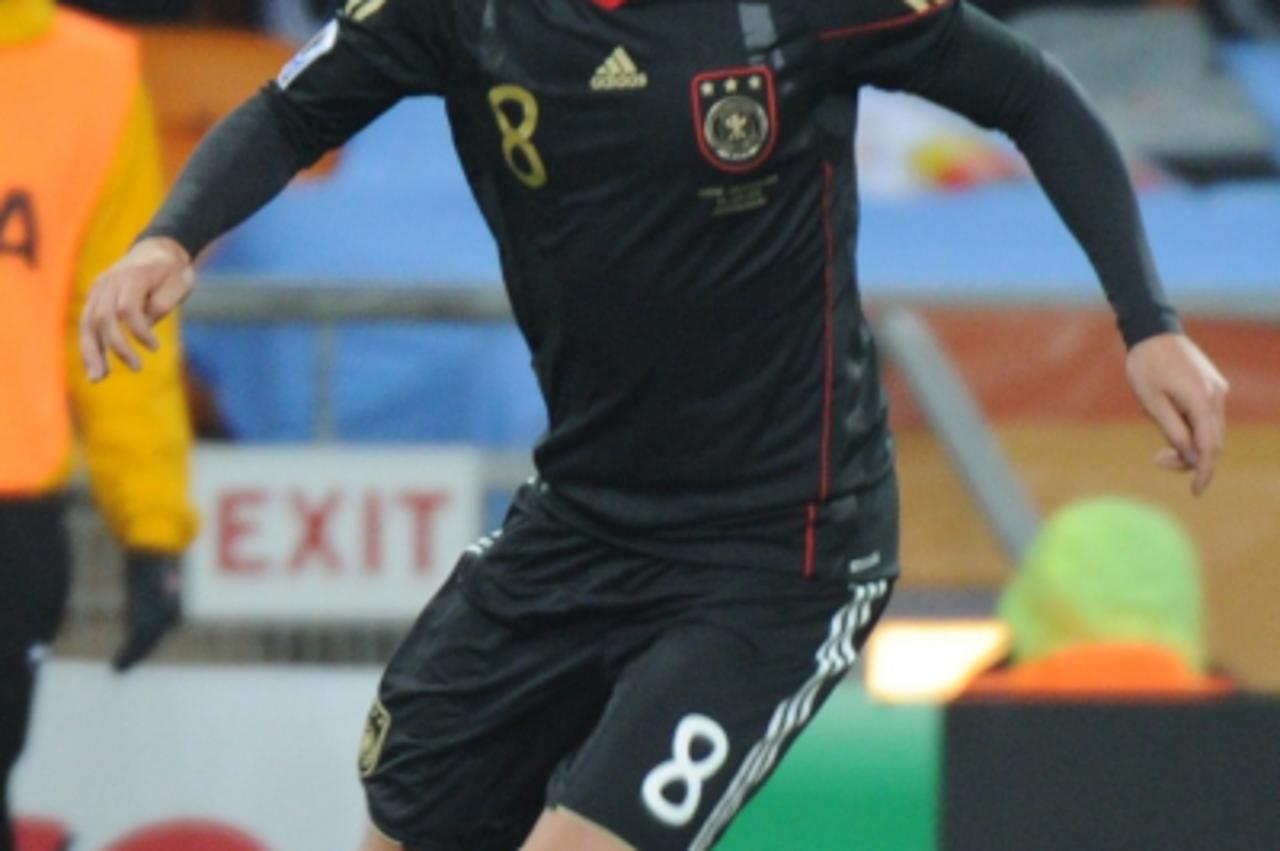 'Germany\'s midfielder Mesut Ozil scores a goal during their Group D first round 2010 World Cup football match on June 23, 2010 at Soccer City stadium in Soweto, suburban Johannesburg. NO PUSH TO MOBI