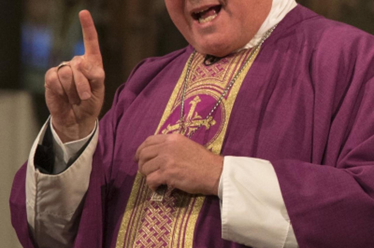 'Cardinal Timothy Dolan, the Archbishop of New York, leads mass at Saint Patrick's Cathedral on Ash Wednesday in New York February 13, 2013. REUTERS/Adrees Latif  (UNITED STATES - Tags: RELIGION ANNI