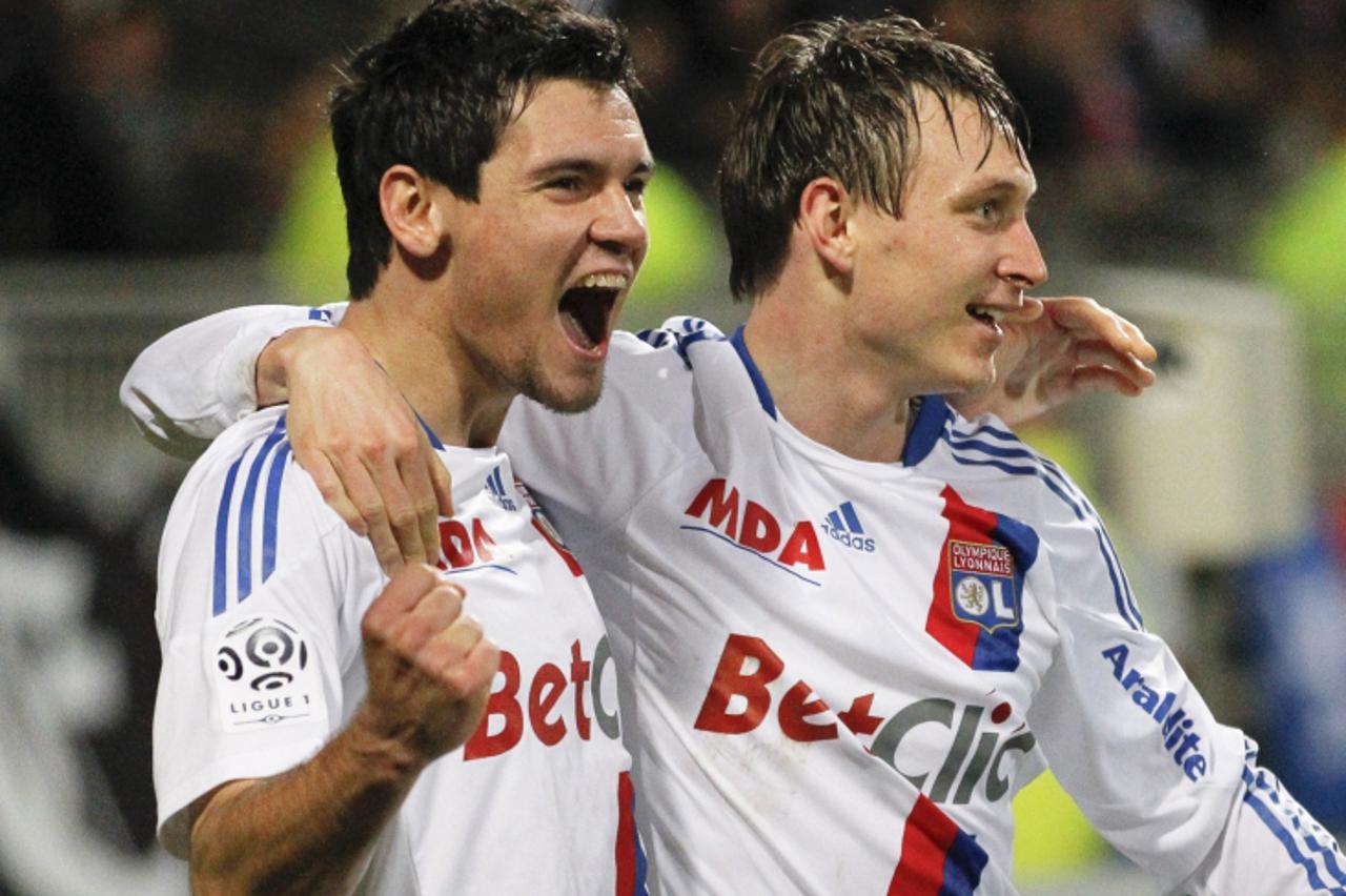 'Olympique Lyon's Kim Kallstrom (R) celebrates with team mate Dejan Lovren his team's first goal against Auxerre during their French Ligue 1 soccer match at the Gerland stadium in Lyon December 22,