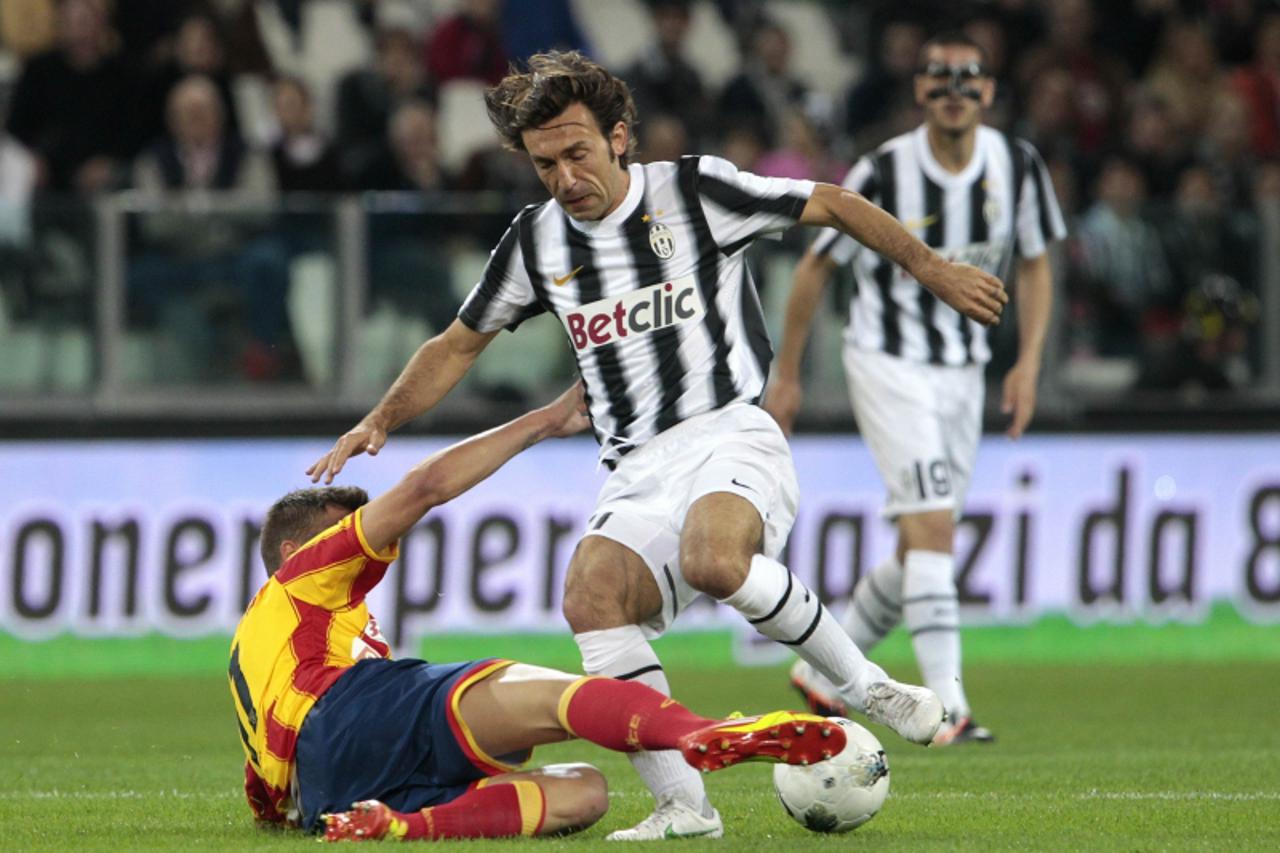 'Juventus\' Andrea Pirlo (L) challenges Lecce\'s Haris Seferovic during their Italian Serie A soccer match at the Juventus stadium in Turin May 2, 2012.     REUTERS/Stefano Rellandini  (ITALY - Tags: 