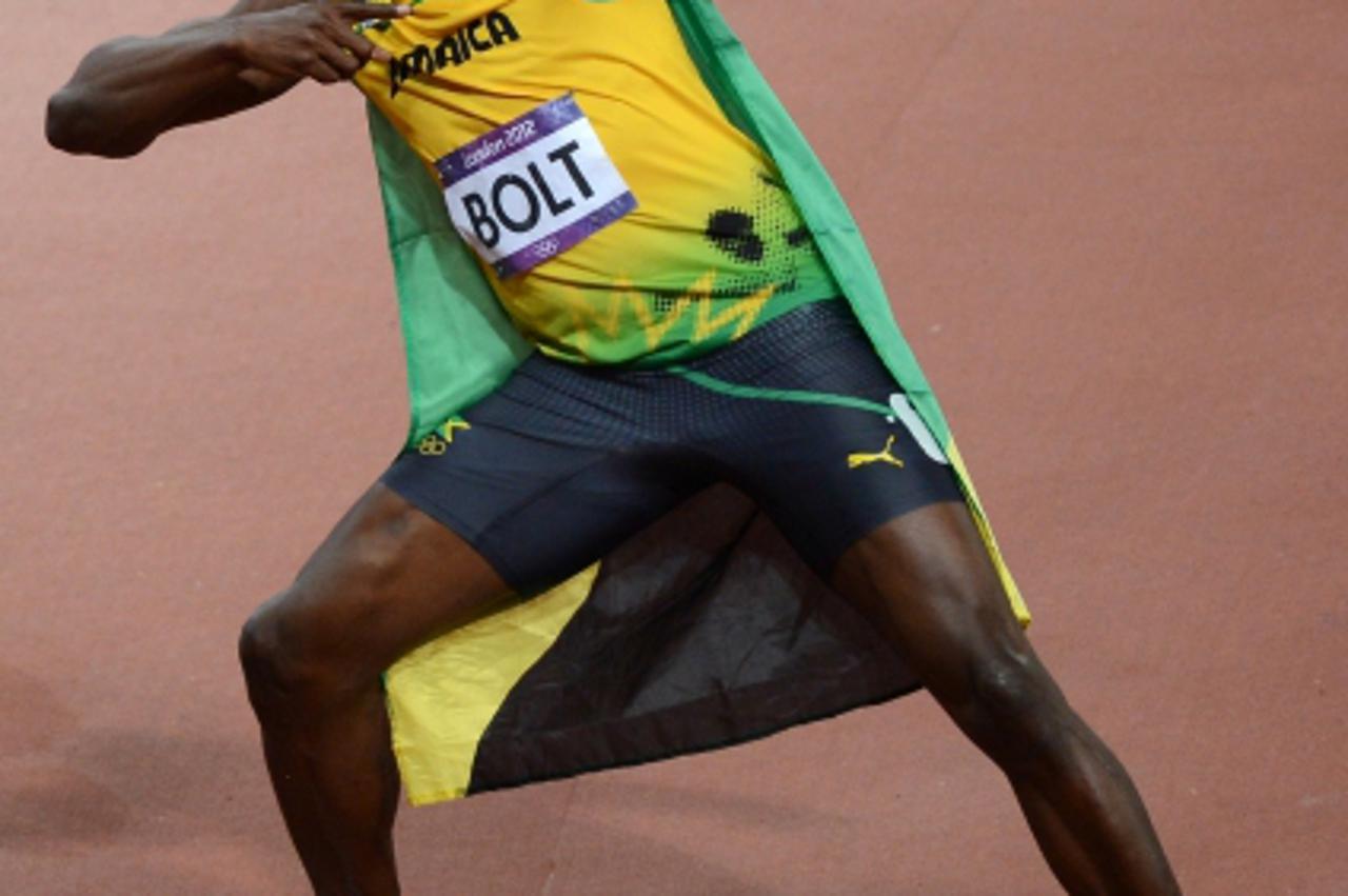'Jamaica\'s Usain Bolt celebrates after he won the  men\'s 100m final at the athletics event of the London 2012 Olympic Games on August 5, 2012 in London.   AFP PHOTO / JOHANNES EISELE'