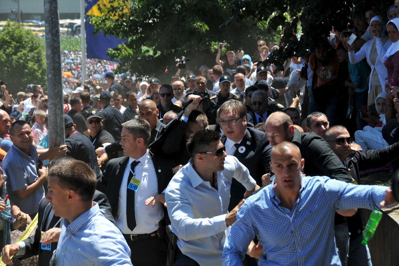 Bodyguards protect Serbia's Prime Minister Aleksandar Vucic during unrest at a ceremony marking the 20th anniversary of the Srebrenica massacre, in Potocari, near Srebrenica, Bosnia and Herzegovina July 11, 2015. Vucic was forced to flee the ceremony on S