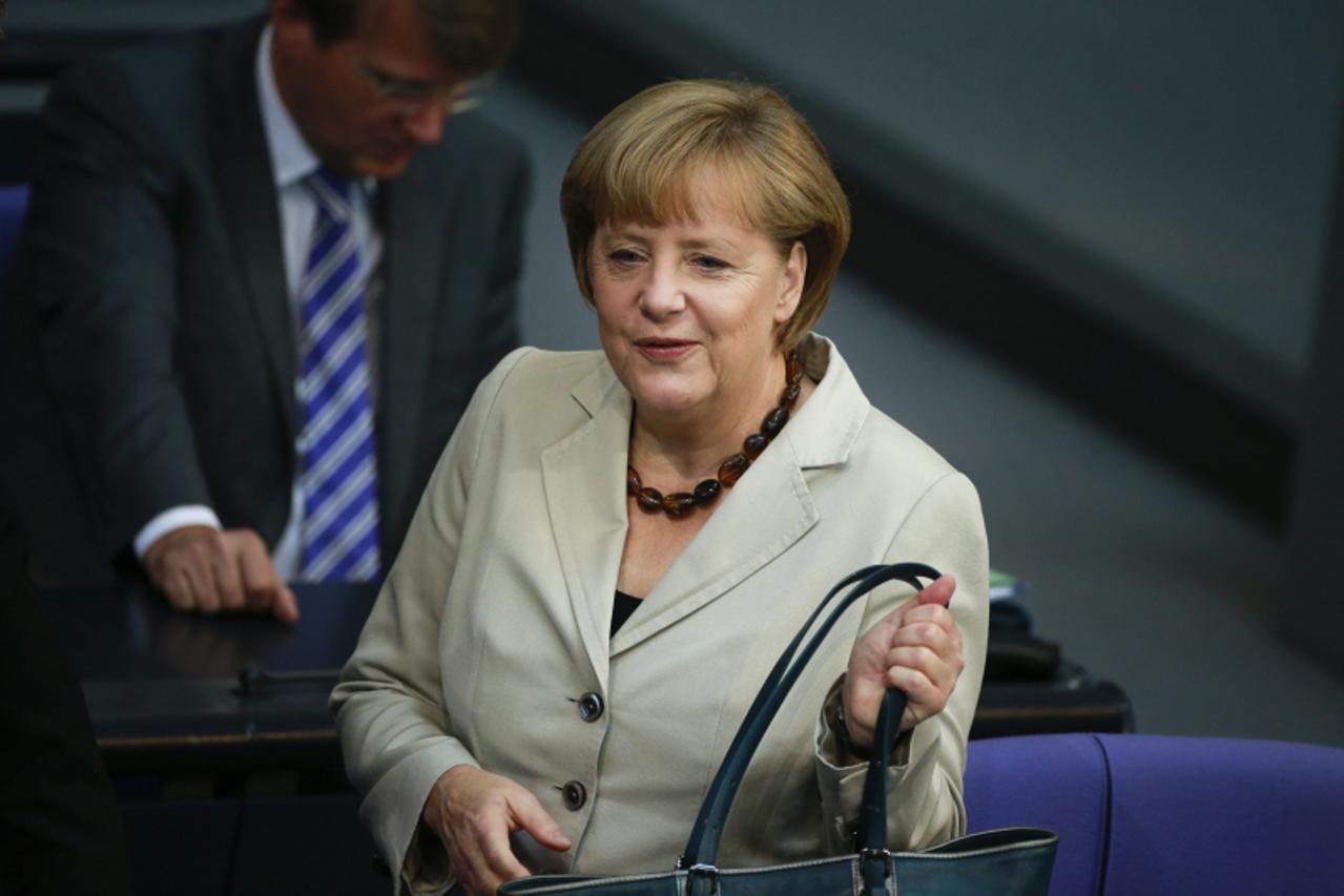 'German Chancellor Angela Merkel arrives at the the lower house of parliament, the Bundestag, in Berlin to deliver a government policy statement on her European policies, June 27, 2013.  REUTERS/Thoma