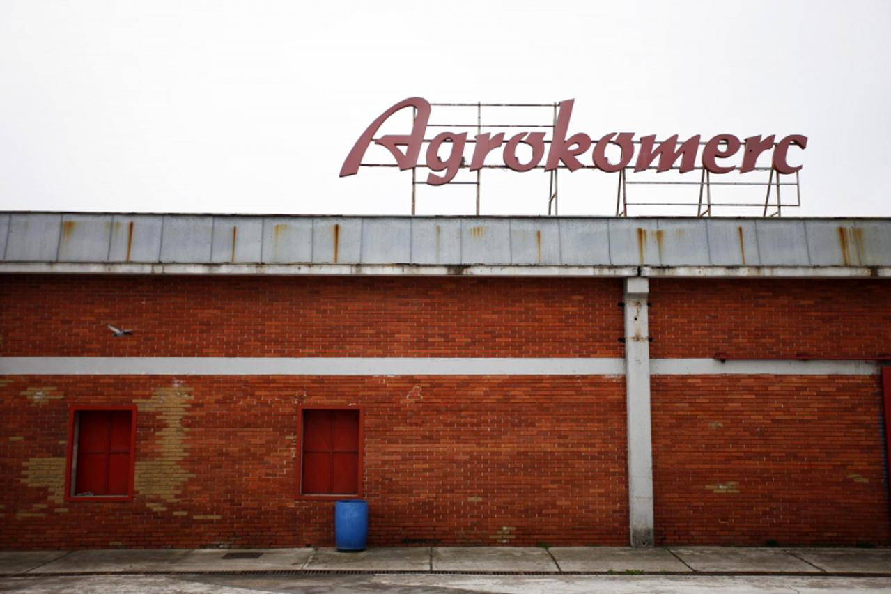 'The logo of Agrokomerc stands on top of an abandoned food processing building near Velika Kladusa, April 3, 2012. Five gutted houses and a moth-balled factory are all that remains in this northern Bo