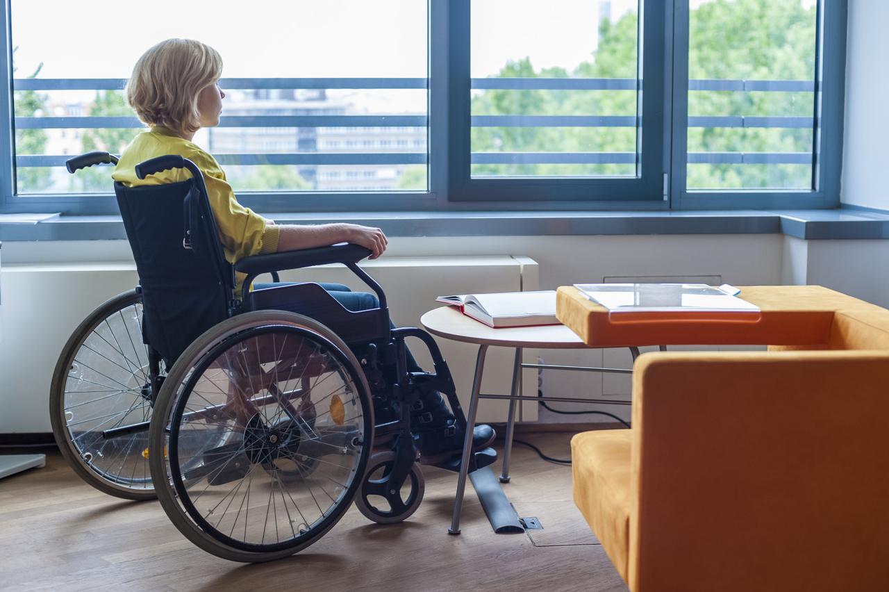 Young woman sitting on a wheelchair