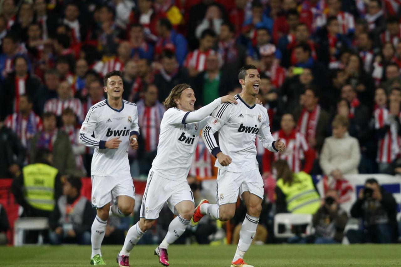 'Real Madrid Cristiano Ronaldo (R) celebrates his goal with teammates Luka Modric (C) and Mesut Ozil against Atletico Madrid during their Spanish King\'s Cup final soccer match at Santiago Bernabeu st