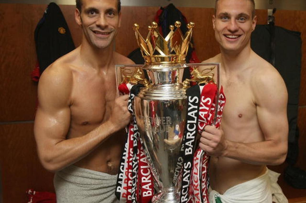 'MANCHESTER, ENGLAND - MAY 16: (EXCLUSIVE ACCESS - MINIMUM USAGE FEE APPLIES - 250 GBP OR LOCAL EQUIVALENT) Rio Ferdinand and Nemanja Vidic of Manchester United celebrates with the Premier League trop