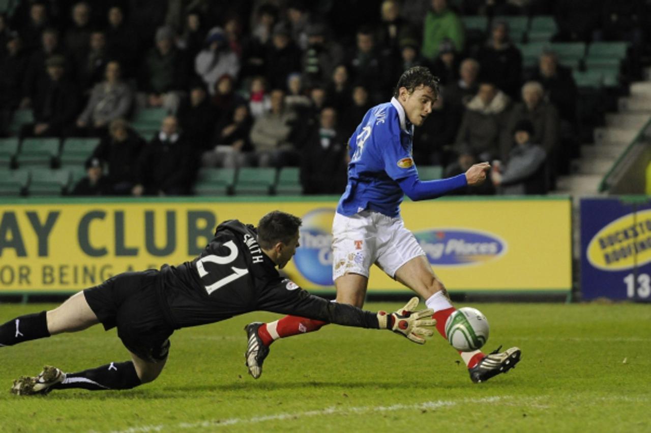 'Rangers\' Nikica Jelavic scores against Hibs during their Scottish Premier League soccer match at Easter Road , Edinburgh, Scotland, January 26, 2011. REUTERS/Russell Cheyne (BRITAIN - Tags: SPORT SO