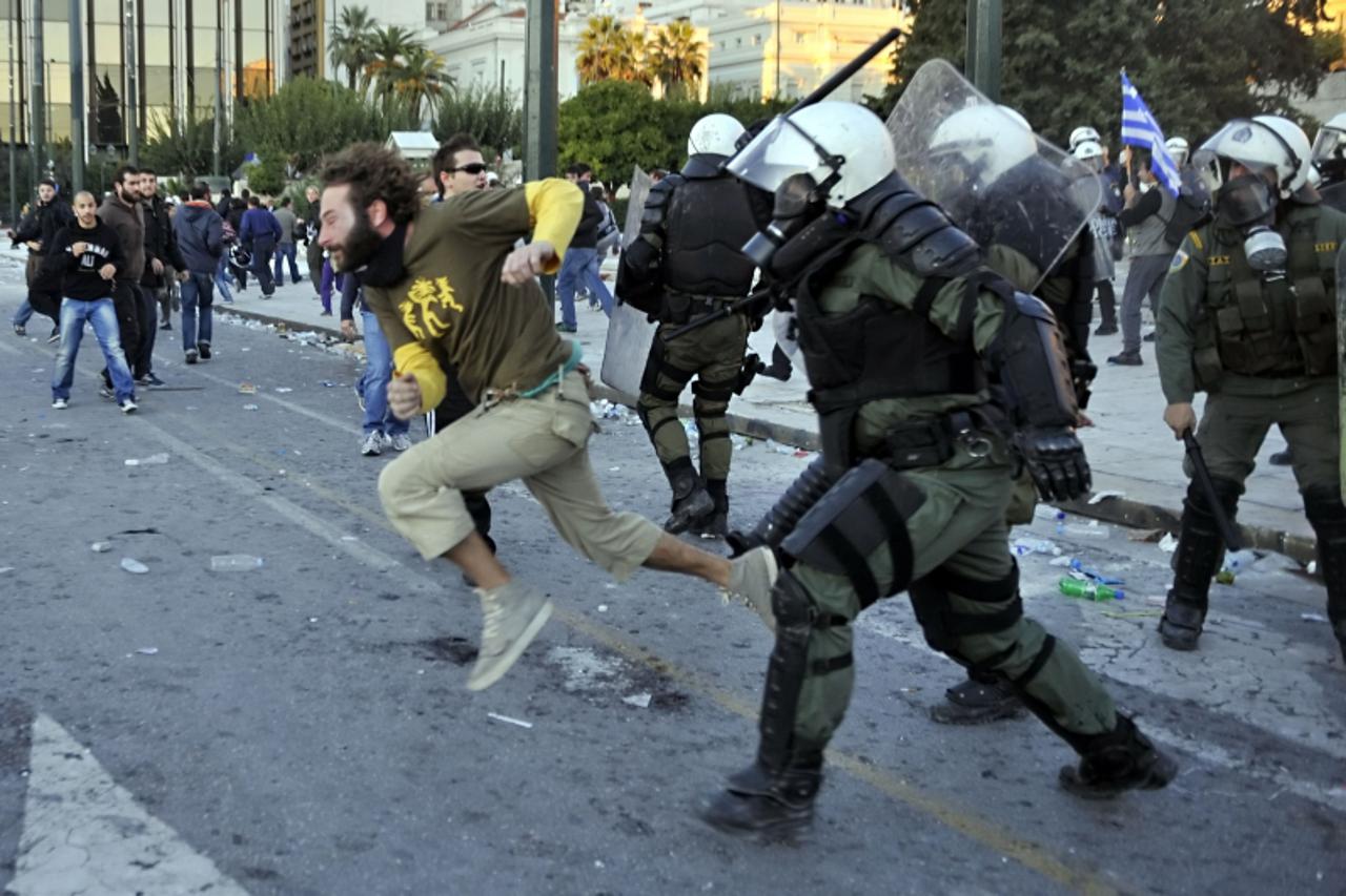 'Police tries to disperse peaceful protesters from central Athens Syntagma square on October 19, 2011. Violence marred huge demonstrations in Greece as unions launched a two-day general strike ahead o