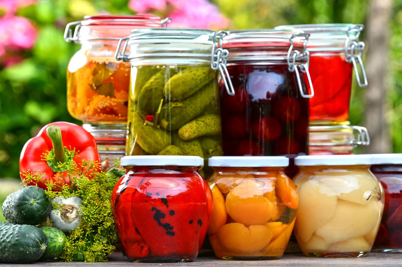 Jars of pickled vegetables and fruits in the garden