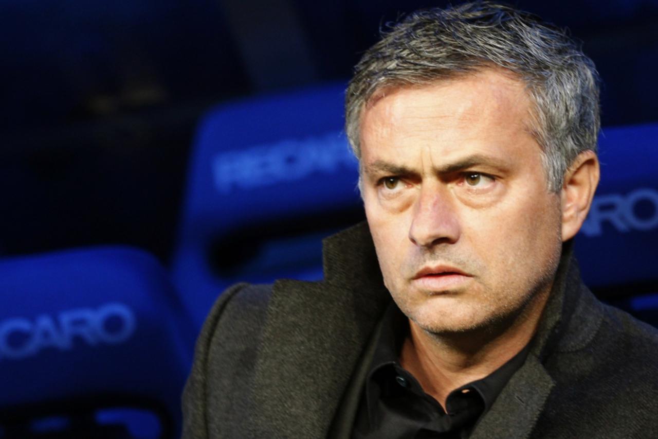 \'Real Madrid\'s coach Jose Mourinho looks from the bench before his Spanish first division soccer match against Hercules at Santiago Bernabeu stadium in Madrid March 12, 2011.  REUTERS/Sergio Perez  