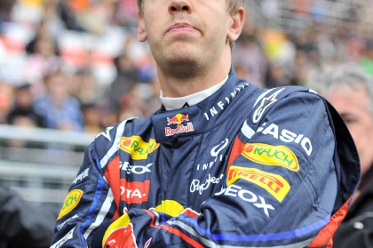 'Red Bull-Renault driver Sebastian Vettel of Germany stands on the starting grid prior to the Formula One Korean Grand Prix in Yeongam on October 16, 2011. Vettel won the Korean Grand Prix in crushing