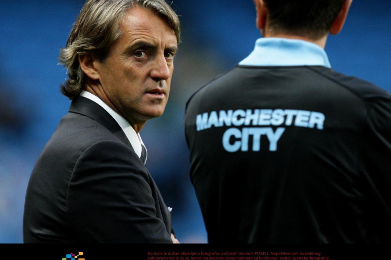 \'Manchester City manager Roberto Mancini talks to a member of his backroom staff before the UEFA Champions League, Group A match at the Etihad Stadium, Manchester. Photo: Press Association/Pixsell\'