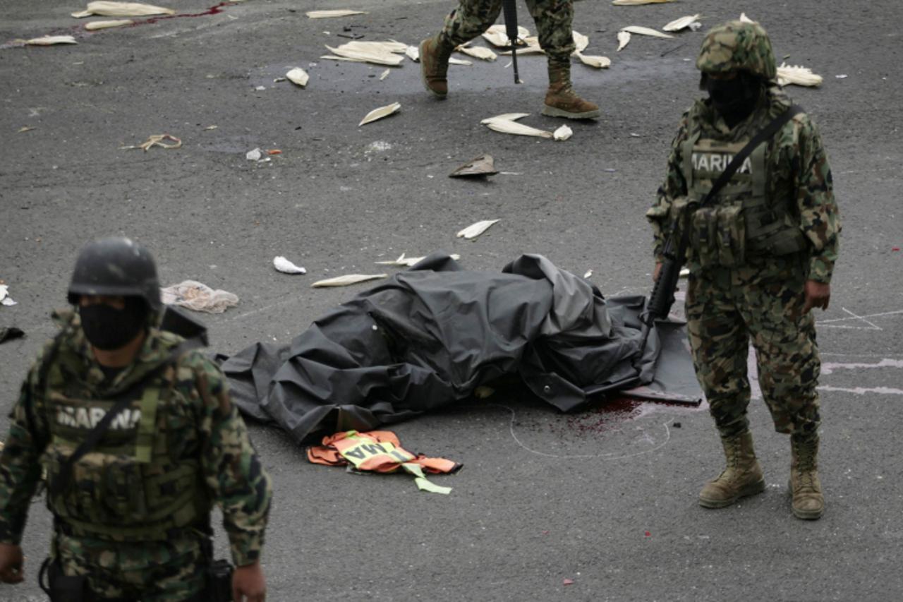 'ATTENTION EDITORS - VISUAL COVERAGE OF SCENES OF DEATH AND INJURY   The body of a dead soldier lies in between two soldiers after a truck accident in the motorway in the outskirts of Mexico City Sept