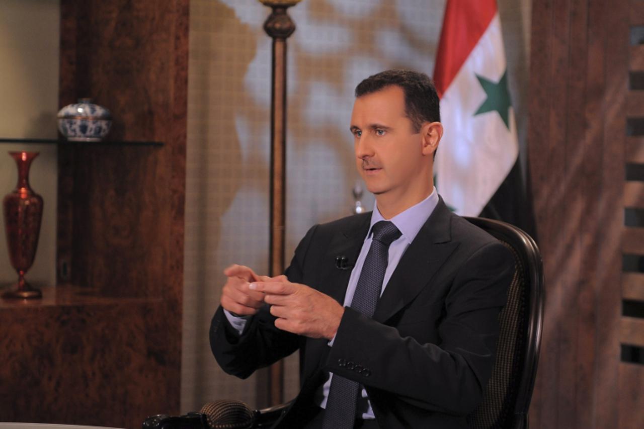 'Syria's President Bashar Assad speaks during an interview with Syrian state television in Damascus August 21,2011, in this handout photograph released by Syria's national news agency SANA. Syrian 