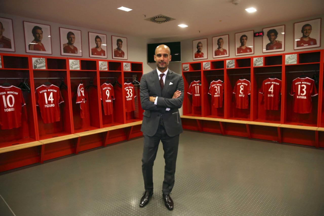 'Bayern Munich new head coach Pep Guardiola poses in the team locker room inside the Allianz Arena June 24, 2013. Treble-winning Bayern Munich unveiled their new coach Guardiola amid a media frenzy on