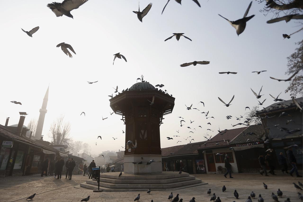 A flock of pigeons fly over the Bascarsija square as smog blankets the old part of Bosnia's capital Sarajevo, Bosnia and Herzegovina, December 28, 2015. According to local media, the smog had cleared enough for the sun to be spotted for the first time in 