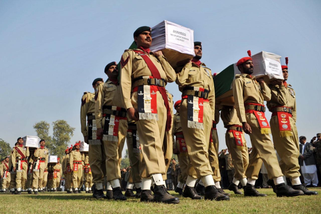 \'Pakistani soldiers carry the coffins of their comrades who were killed in a NATO strike during a funeral ceremony in Peshawar on November 27, 2011. The United States moves to salvage ties with Pakis