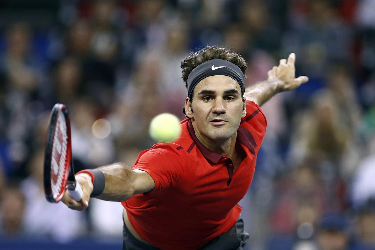 Roger Federer of Switzerland returns a shot to Gilles Simon of France during the men's singles final match at the Shanghai Masters tennis tournament in Shanghai October 12, 2014. REUTERS/Aly Song (CHINA - Tags: SPORT TENNIS TPX IMAGES OF THE DAY)