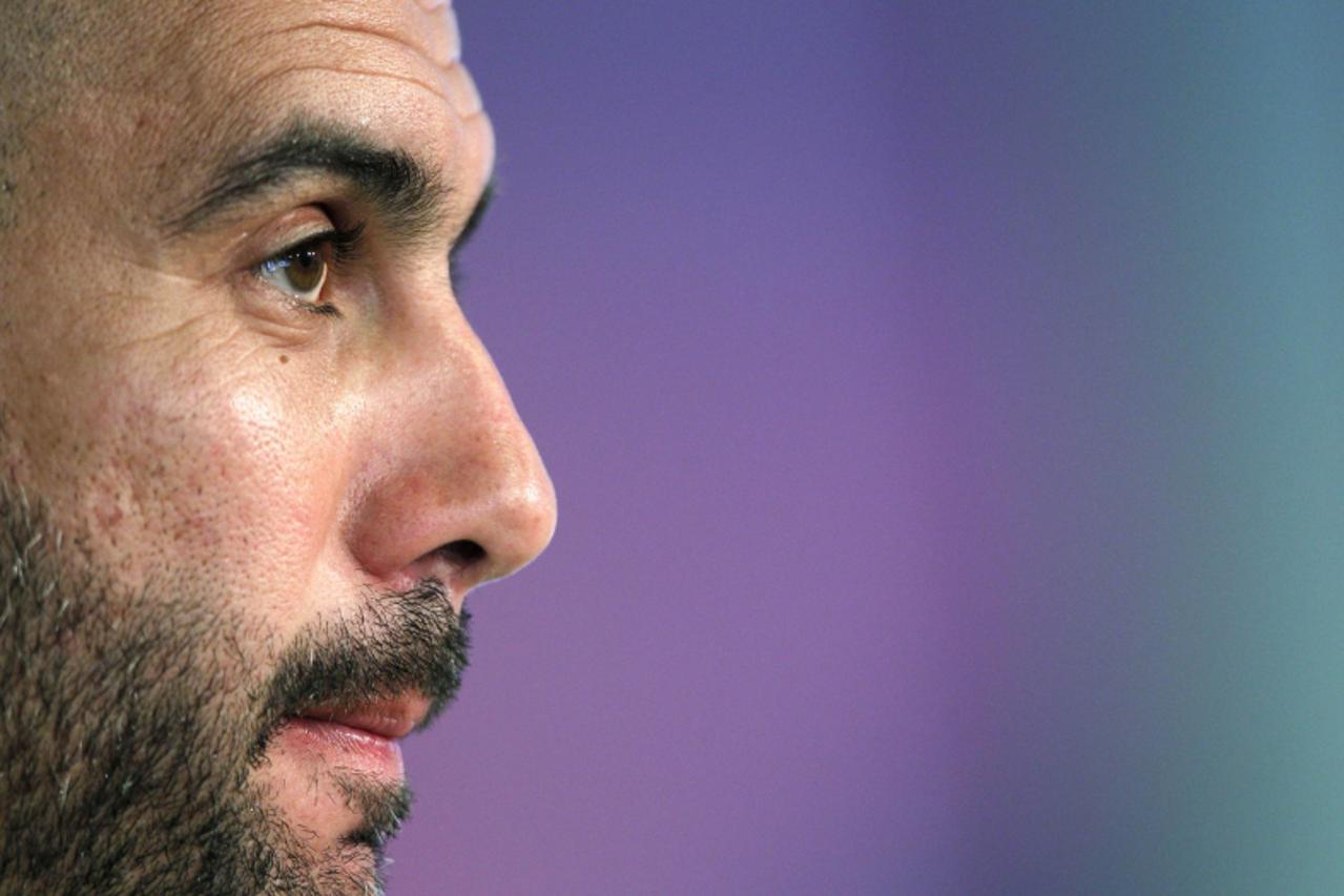 'Barcelona\'s coach Pep Guardiola attends a news conference at Joan Gamper traning camp, near Barcelona, March 16, 2012. REUTERS/Albert Gea (SPAIN - Tags: SPORT SOCCER)'