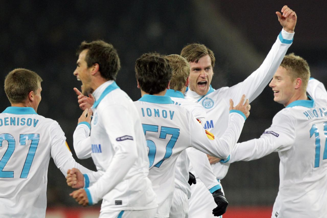 \'Zenit St. Petersburg\'s Nicolas Lombaerts (C) celebrates with team mates after scoring goal against BSC Young Boys during their UEFA Europa League round of 32 first leg football match on February 17