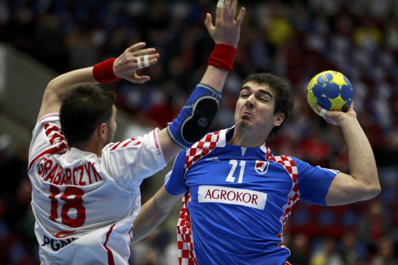 \'Croatia\'s Denis Buntic (R) attempts to score next to Poland\'s Piotr Grabarczyk during their main round match at the Men\'s Handball World Championship in Malmo January 25, 2011.  REUTERS/Marcelo D
