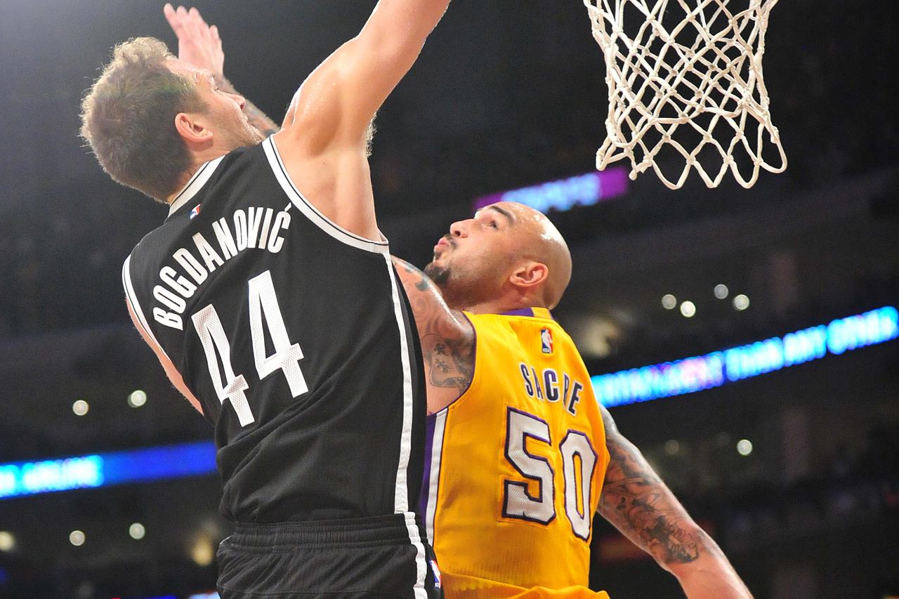 February 20, 2015; Los Angeles, CA, USA; Brooklyn Nets guard Bojan Bogdanovic (44) dunks to score a basket against the defense of Los Angeles Lakers center Robert Sacre (50) during the first half at Staples Center. Mandatory Credit: Gary A. Vasquez-USA TO