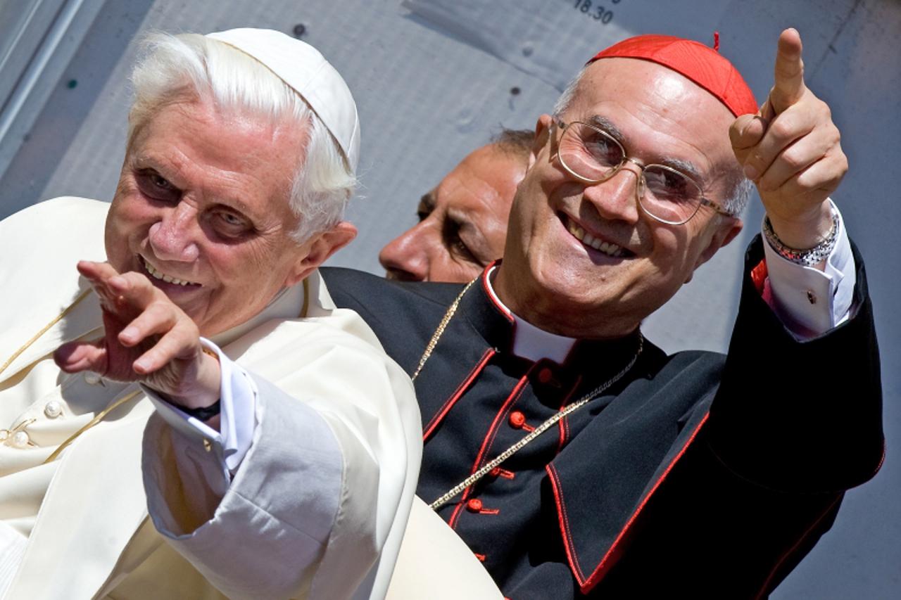 'Pope Benedict XVI (L) and Vatican Secretary of State Cardinal Tarcisio Bertone wave as they leave after the Sunday Angelus prayer on July 19, 2009 in Romano Canavese, near Ivrea, in north-western Ita