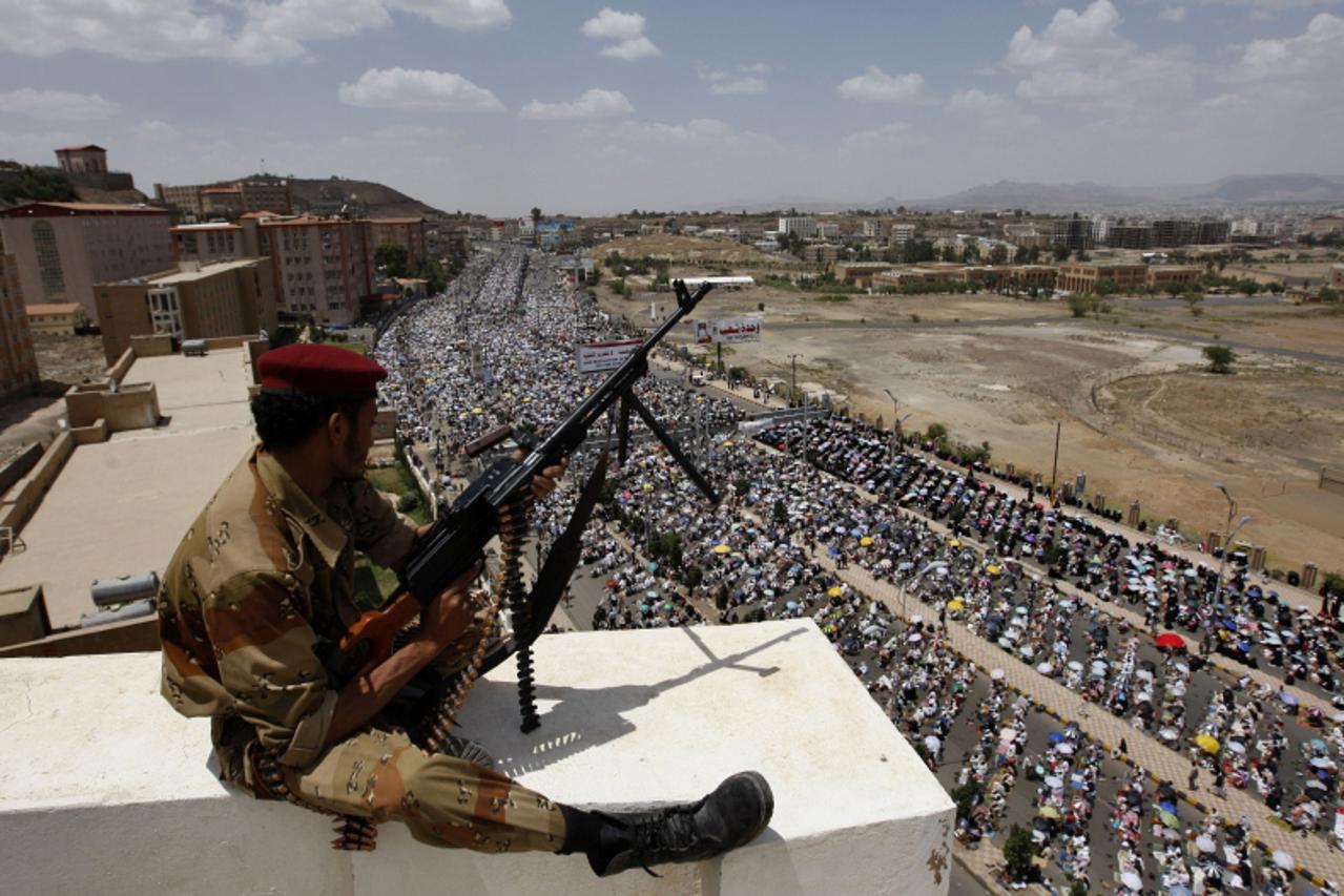 'A Yemeni army soldier loyal to dissident General Ali Mohsen al-Ahmar monitors a demonstration by tens of thousands of anti-regime protesters in central Sanaa against President Ali Abdullah Saleh afte