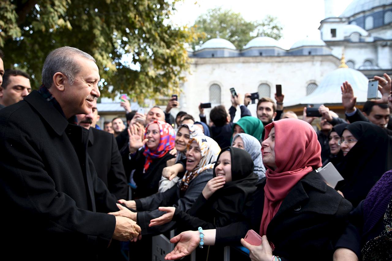 Turkish President Tayyip Erdogan (L) is greeted by his supporters during his visit to the Eyup Sultan mosque in Istanbul, Turkey, November 2, 2015 in this handout photo provided by Presidential Press Office. President Erdogan said on Monday the nation had