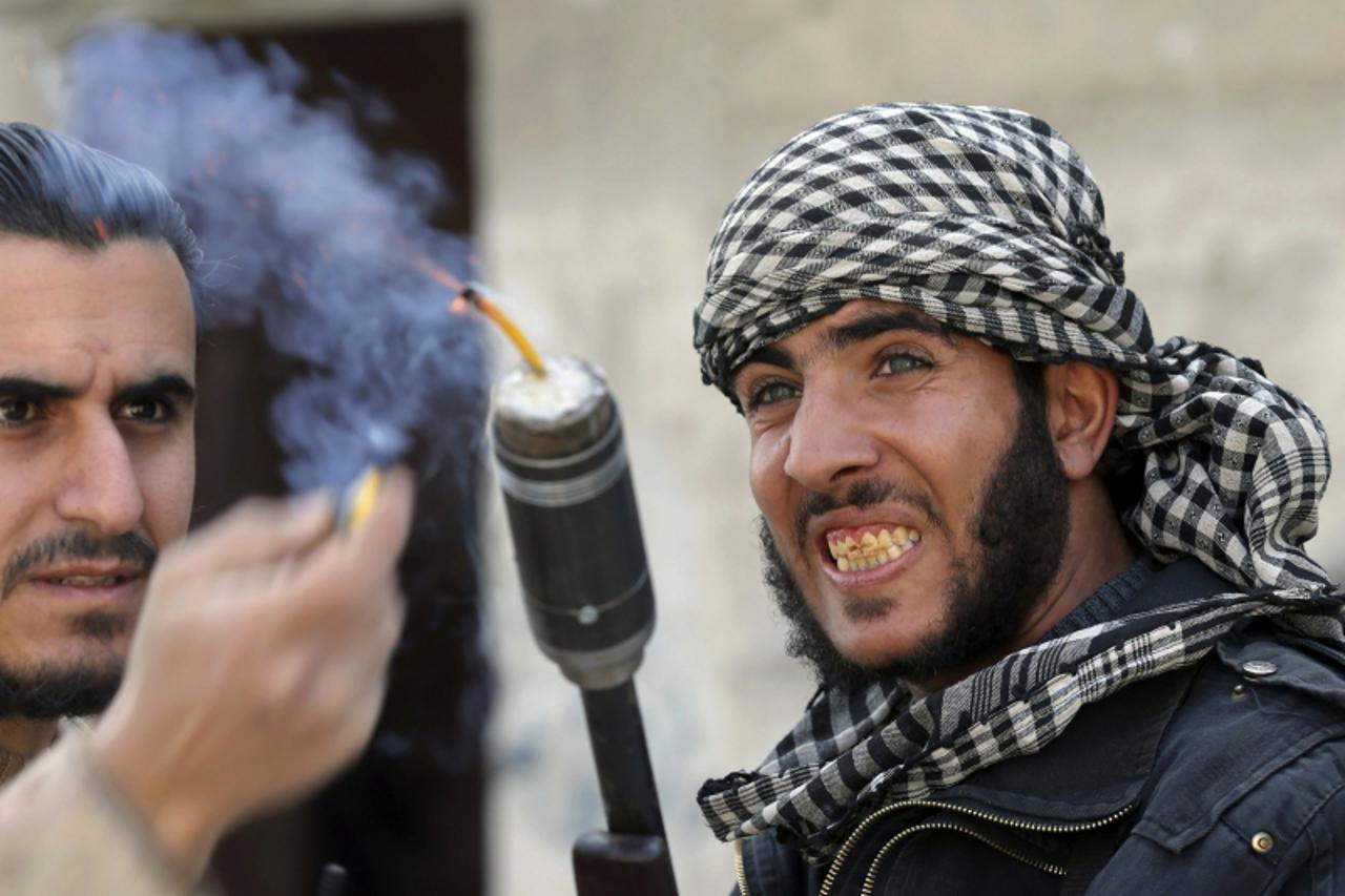 'Fighters from the Free Syrian Army's Tahrir al Sham brigade use a shotgun to fire an improvised grenade at Syrian Army soldiers in the Arabeen neigbourhood of Damascus February 9, 2013. REUTERS/Gora