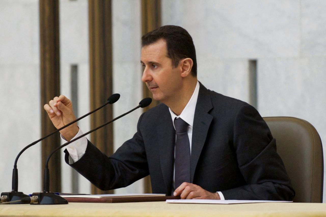 'Syria\'s President Bashar al-Assad heads the plenary meeting of the central committee of the ruling al-Baath party, in Damascus in this handout photograph distributed by Syria\'s national news agency