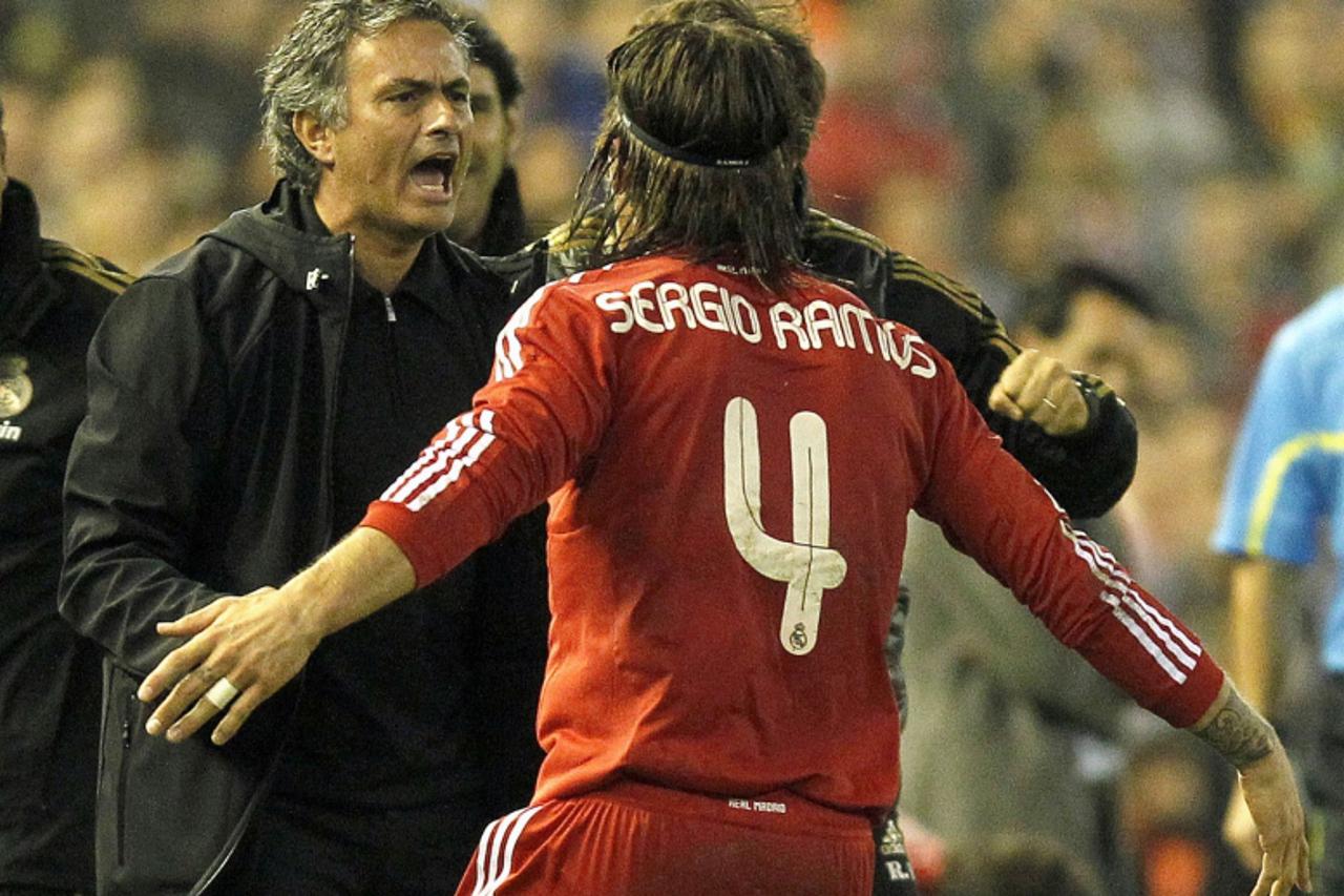 'Real Madrid\'s Sergio Ramos celebrates next to coach Jose Mourinho after he scored against Valencia during their Spanish first division soccer match at the Mestalla Stadium in Valencia, November 19, 