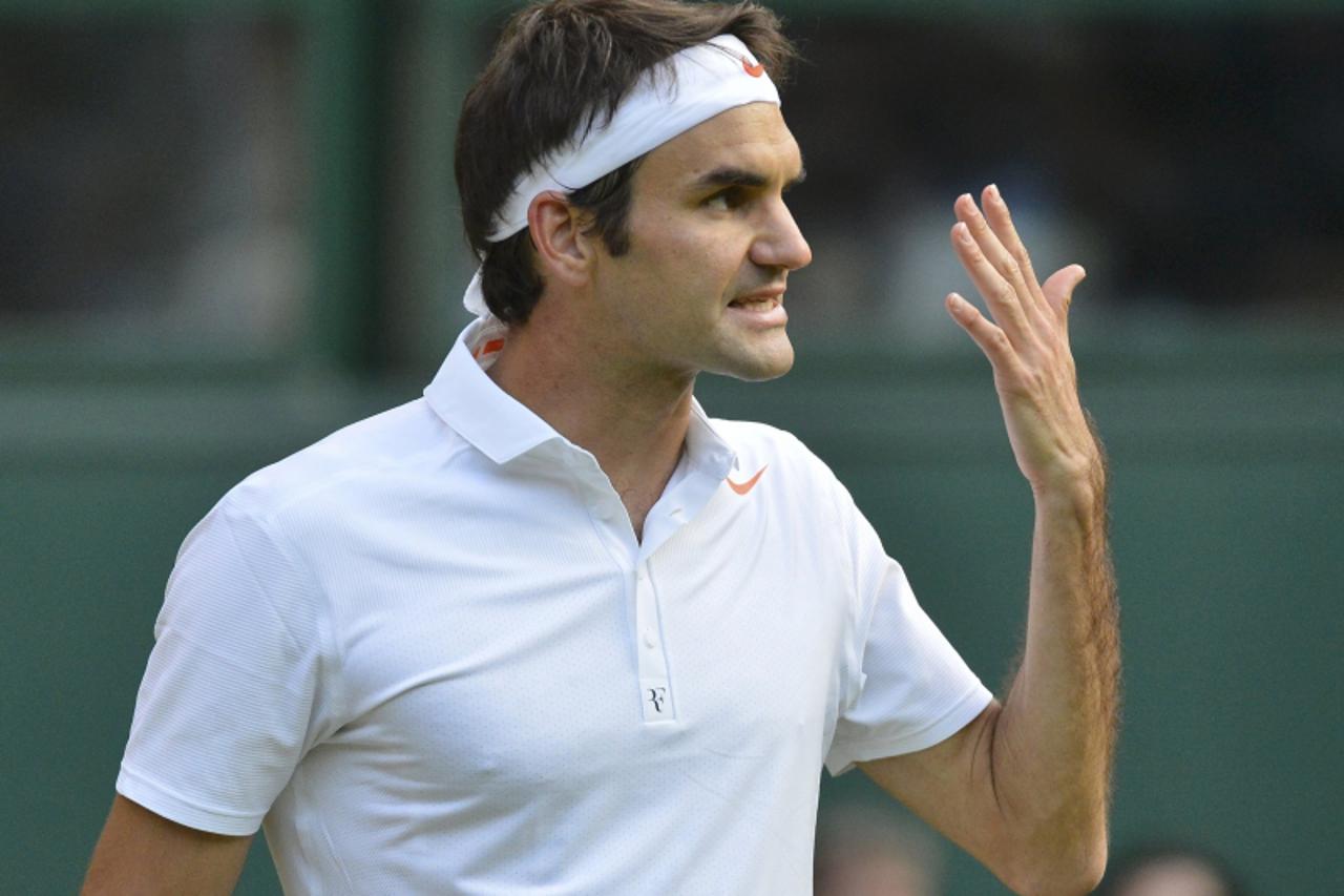 'Roger Federer of Switzerland argues with the umpire during his men's singles tennis match against Sergiy Stakhovsky of Ukraine at the Wimbledon Tennis Championships, in London June 26, 2013.        