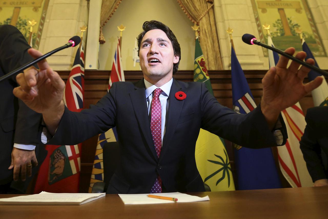 Canada's Prime Minister Justin Trudeau adjusts his microphones before speaking during a Liberal caucus meeting on Parliament Hill in Ottawa, Canada November 5, 2015. REUTERS/Chris Wattie      TPX IMAGES OF THE DAY     