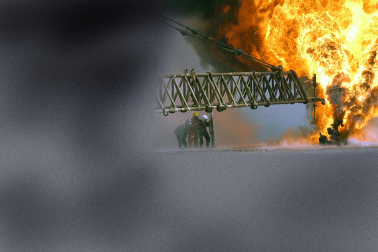 \'030328-M-0000X-005 Southern Iraq (Mar. 27, 2003) -- Kuwaiti firefighters fight an oil blaze at the Rumaila Oilfield as part of their ongoing support of Operation Iraqi Freedom, the multi-national co
